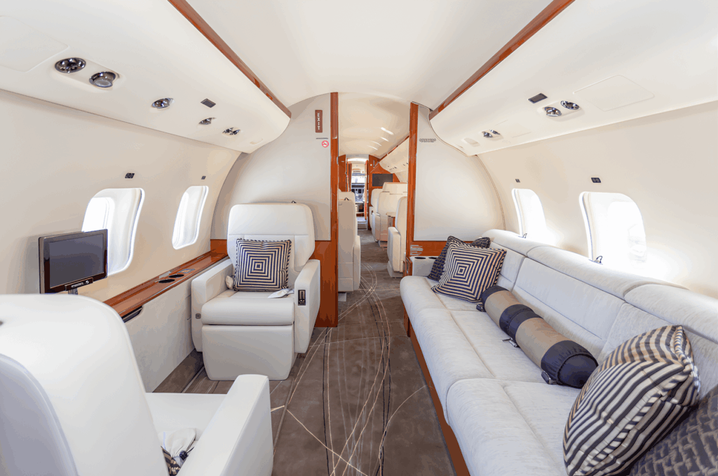 Interior cabin of a Bombardier Global Express private jet with cream leather seating
