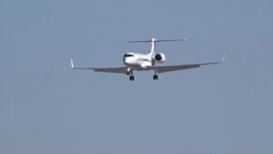 Private jet on final approach, landing gear down